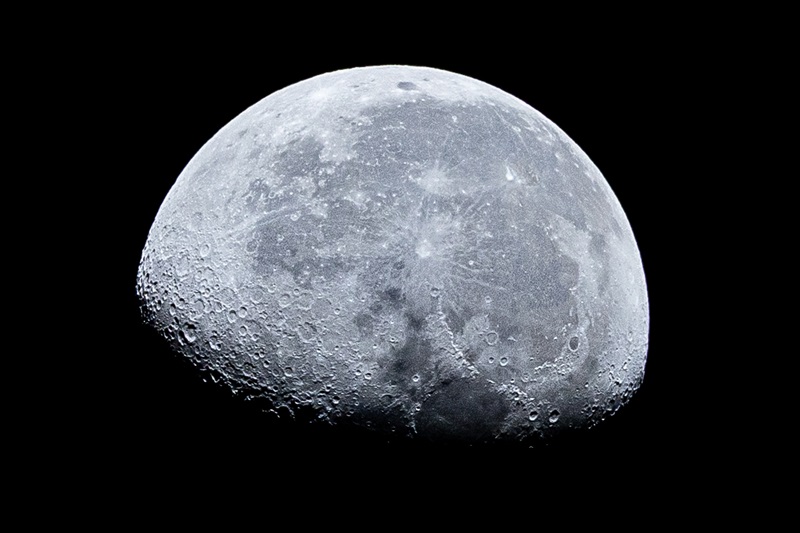 Image of the Moon on 8 April 2026 at almost three quarters, bright, showing craters, against the black of space